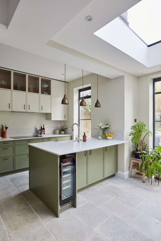 Inspiration for a small transitional l-shaped enclosed kitchen remodel in London with recessed-panel cabinets, green cabinets, quartzite countertops, a peninsula and white countertops