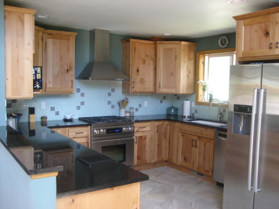 Inspiration for a mid-sized transitional u-shaped ceramic tile and beige floor enclosed kitchen remodel in Denver with recessed-panel cabinets, light wood cabinets, blue backsplash, stainless steel appliances, an island, an undermount sink, granite countertops and ceramic backsplash