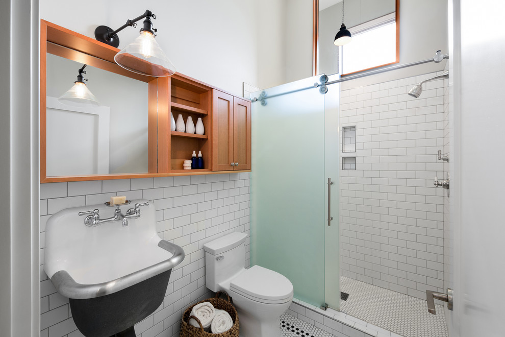 This is an example of a country 3/4 bathroom in Portland with shaker cabinets, light wood cabinets, an alcove shower, white tile, subway tile, beige walls, mosaic tile floors, a wall-mount sink, white floor and a sliding shower screen.
