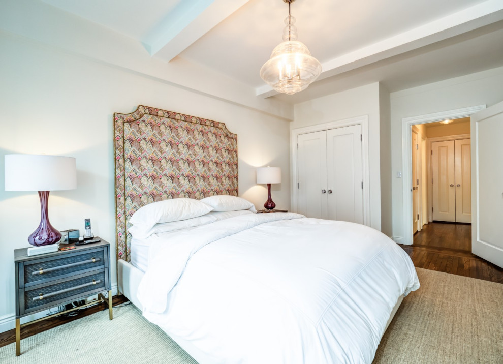 Mid-sized traditional master bedroom in New York with white walls, medium hardwood floors and brown floor.