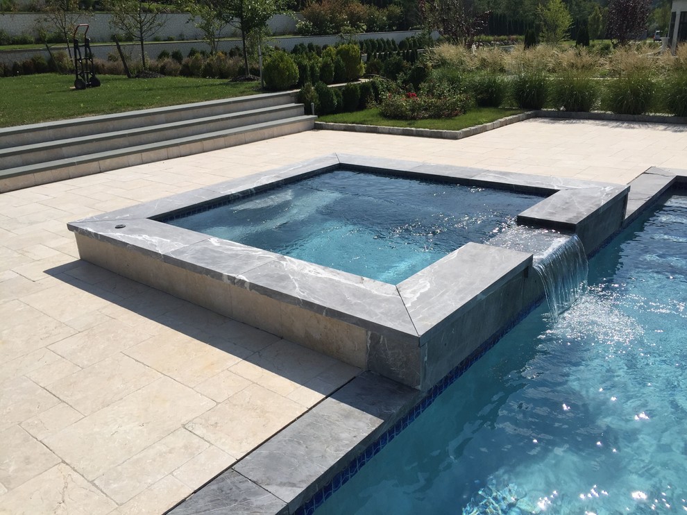 Hot tub - large backyard stone and rectangular lap hot tub idea in New York
