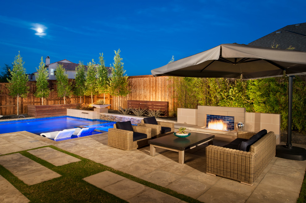 Inspiration for a mid-sized modern backyard l-shaped pool fountain remodel in Dallas with decking