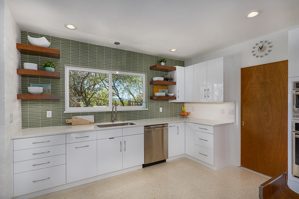 Inspiration for a mid-sized midcentury galley separate kitchen in Phoenix with an undermount sink, flat-panel cabinets, white cabinets, quartz benchtops, green splashback, glass tile splashback, stainless steel appliances, terrazzo floors, with island, beige floor and white benchtop.