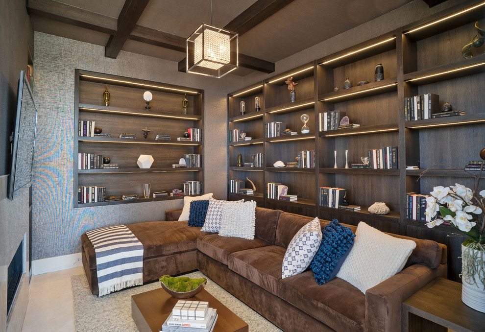 Large beach style enclosed family room in Los Angeles with a library, travertine floors, a wall-mounted tv, brown walls and a ribbon fireplace.