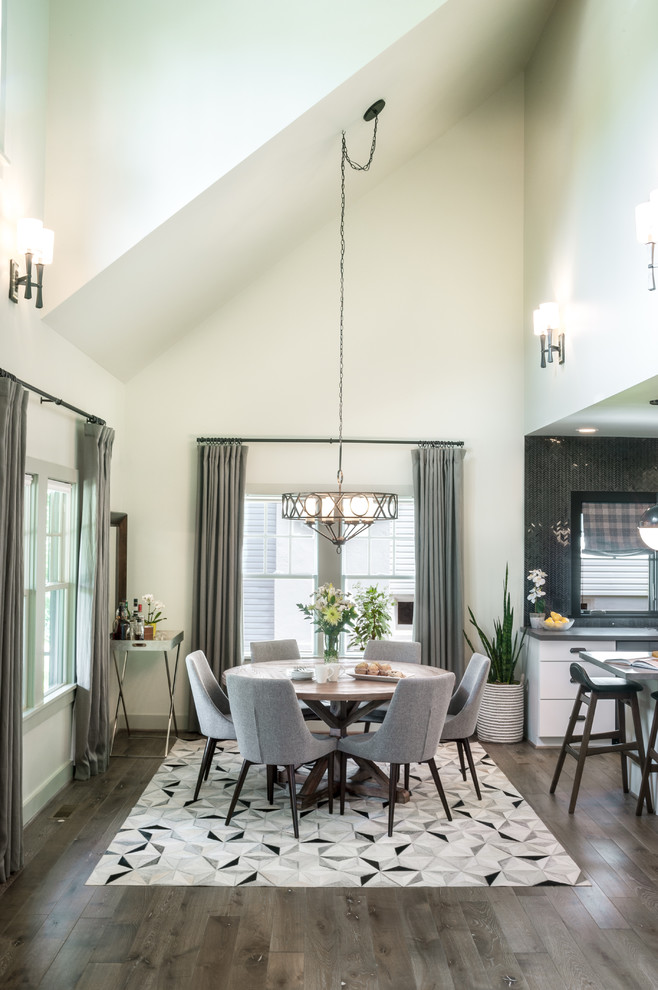 This is an example of a mid-sized contemporary kitchen/dining combo in Detroit with green walls, medium hardwood floors, no fireplace and brown floor.