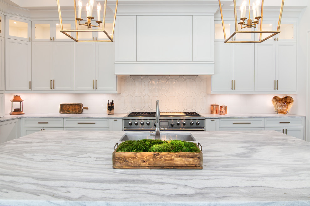 Design ideas for a large transitional u-shaped open plan kitchen in Charlotte with a double-bowl sink, beaded inset cabinets, white cabinets, quartzite benchtops, white splashback, ceramic splashback, panelled appliances, dark hardwood floors, with island and white benchtop.
