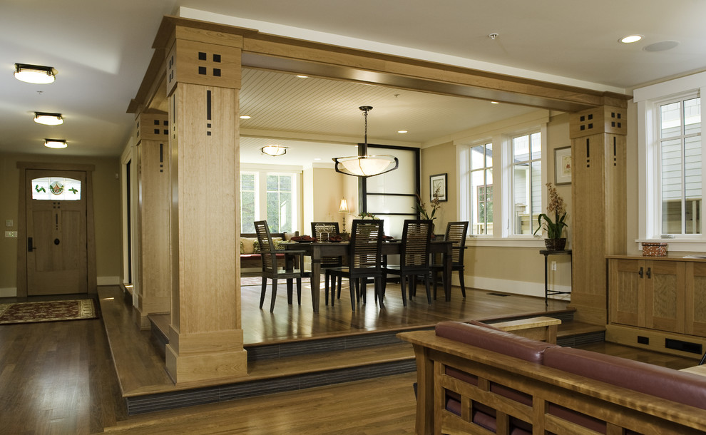 Contemporary dining room in Seattle with beige walls and dark hardwood floors.