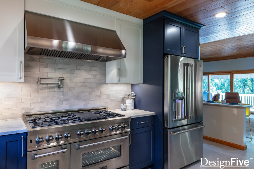 Inspiration for a large modern u-shaped gray floor and wood ceiling open concept kitchen remodel with an undermount sink, shaker cabinets, blue cabinets, quartz countertops, gray backsplash, ceramic backsplash, stainless steel appliances and no island