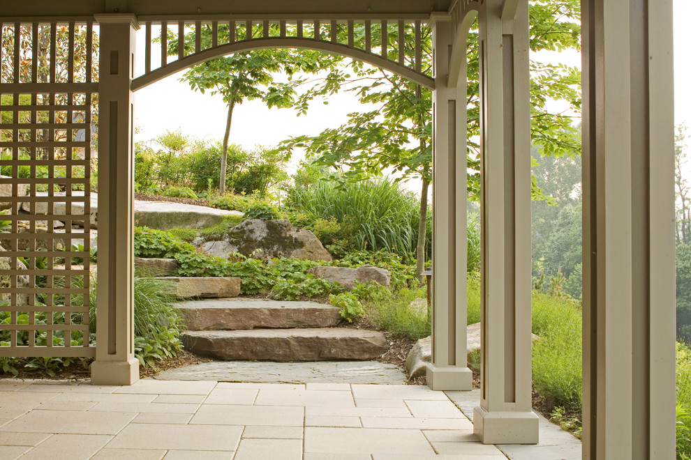 Photo of a mid-sized country backyard partial sun garden in DC Metro with concrete pavers.