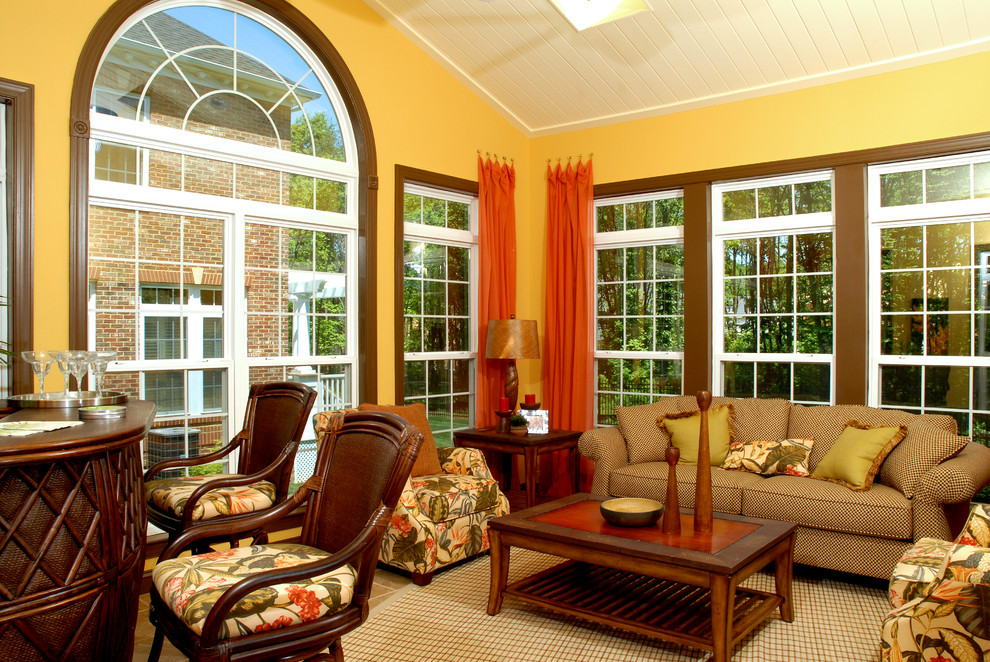 This is an example of a large traditional sunroom in DC Metro with ceramic floors, no fireplace and a skylight.