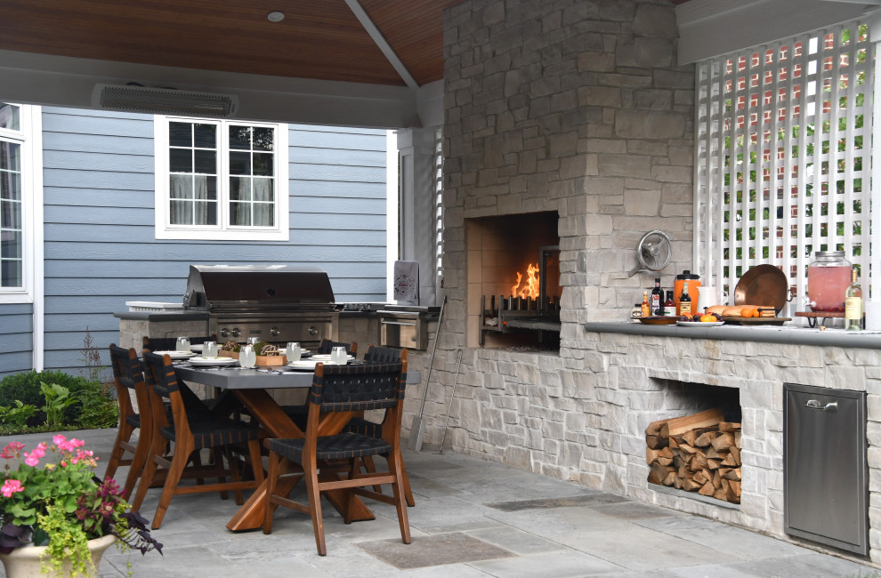 Inspiration for a mid-sized timeless backyard stone patio remodel in Chicago with a fireplace and a gazebo