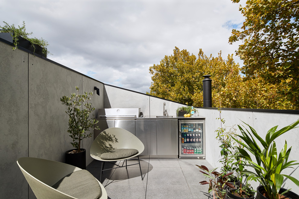 This is an example of a small urban roof rooftop terrace in Melbourne with no cover and a bbq area.