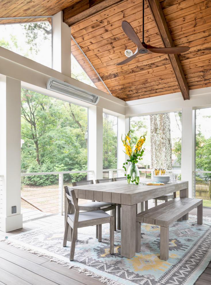 This is an example of a large transitional back porch design in Nashville with a fireplace, decking and a roof extension.