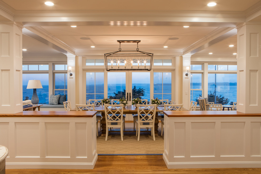 Inspiration for a large beach style open plan dining in Boston with beige walls, medium hardwood floors, no fireplace and brown floor.