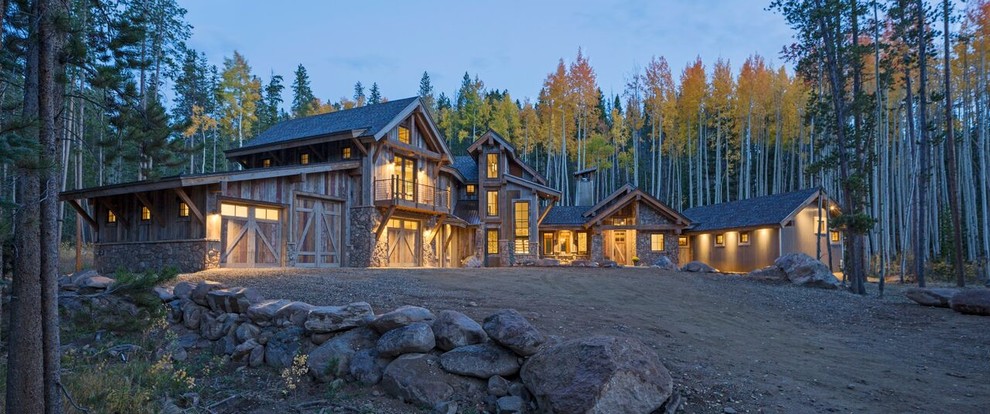 Inspiration for an expansive country three-storey brown exterior in Denver with wood siding and a clipped gable roof.