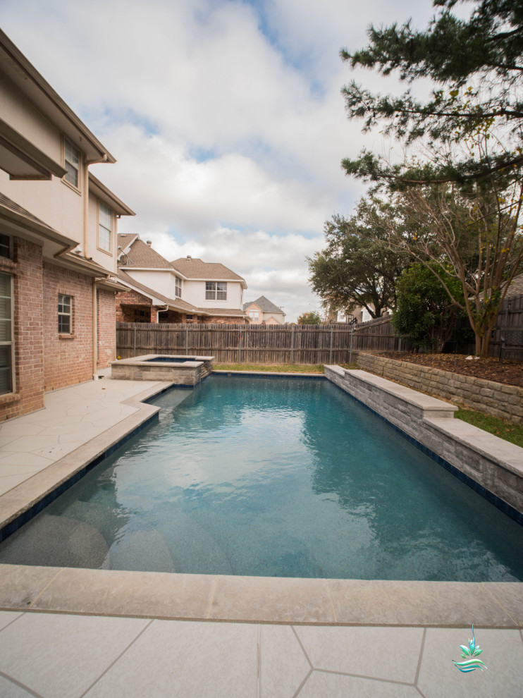 Photo of a large modern backyard custom-shaped natural pool in Dallas with a hot tub and stamped concrete.