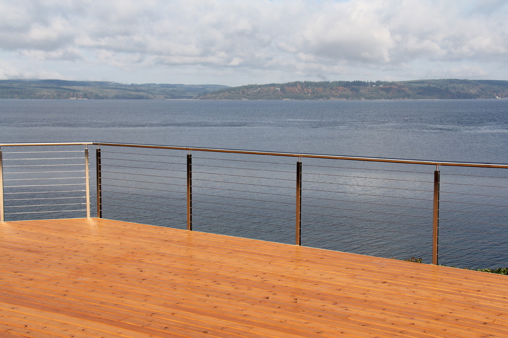 Photo of a large modern backyard deck in Seattle with no cover.