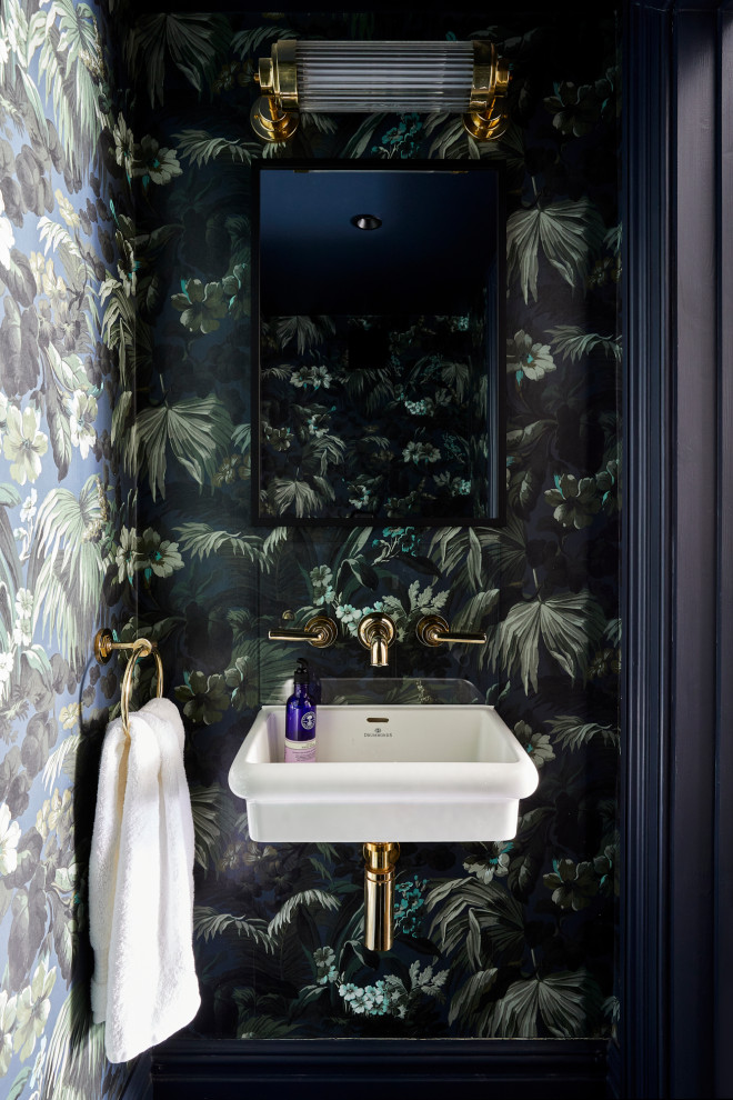 Photo of a small contemporary powder room in London with multi-coloured walls, wallpaper and a wall-mount sink.