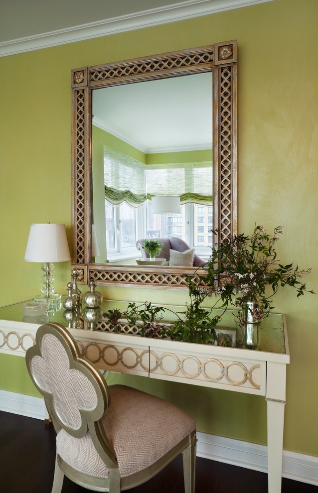 This is an example of a small transitional powder room in Houston with furniture-like cabinets, green walls and dark hardwood floors.