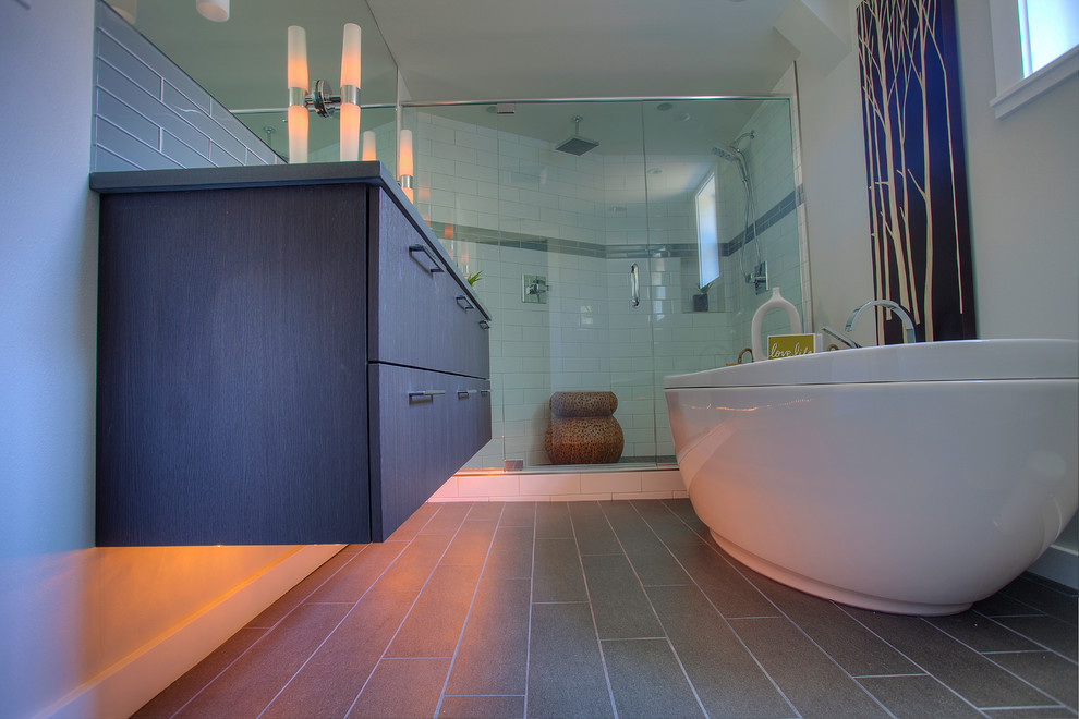 Modern master bathroom in Seattle with flat-panel cabinets, medium wood cabinets, engineered quartz benchtops, white tile, glass tile, a freestanding tub, an open shower, a two-piece toilet, an integrated sink, white walls and porcelain floors.