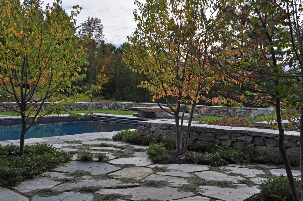 This is an example of a traditional rectangular pool in Burlington with natural stone pavers.