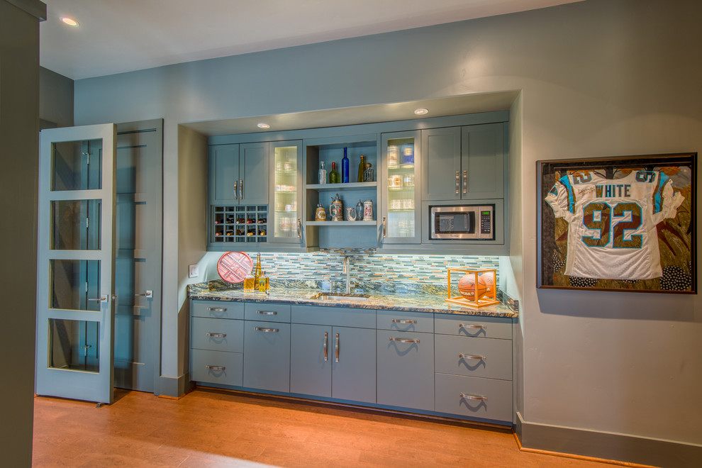 Inspiration for a transitional open concept cork floor family room remodel with a bar and gray walls