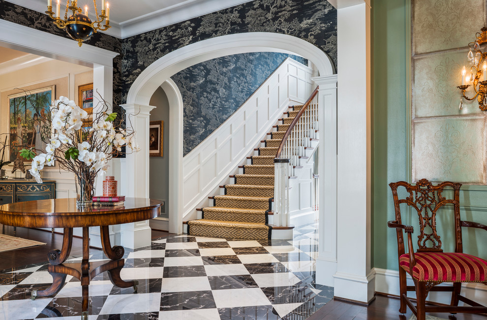 Large traditional foyer in Philadelphia with brown walls, marble floors and a single front door.