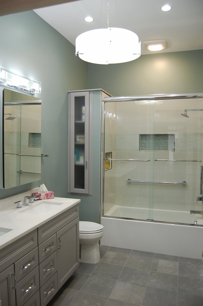 This is an example of a mid-sized modern master bathroom in Atlanta with an undermount sink, grey cabinets, an alcove tub, an alcove shower, a two-piece toilet, gray tile, porcelain tile, porcelain floors, beaded inset cabinets, quartzite benchtops and green walls.