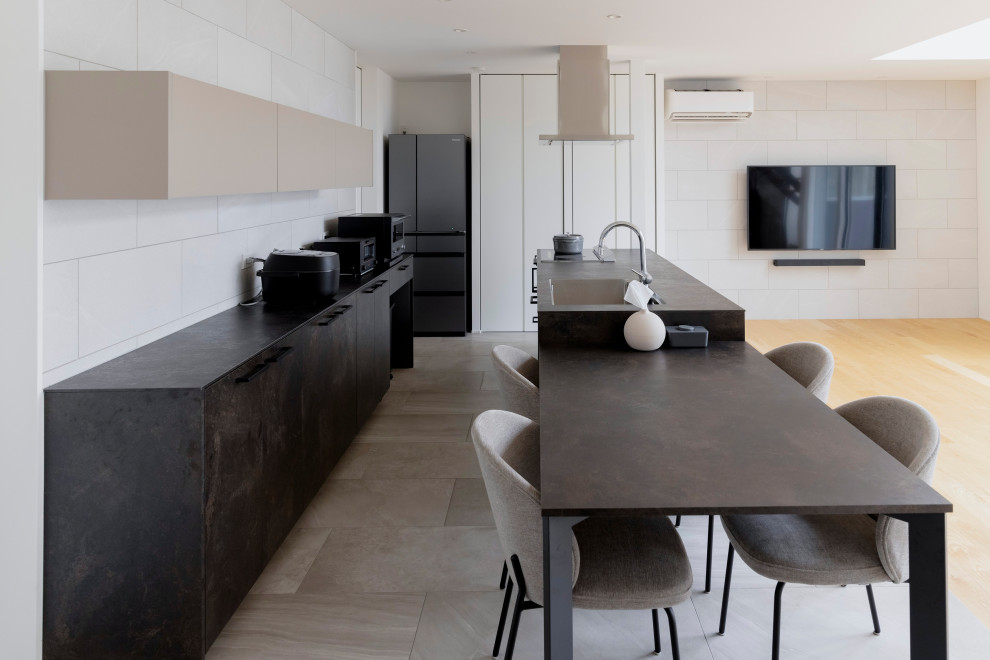 Mid-sized modern single-wall open plan kitchen in Other with an integrated sink, beaded inset cabinets, grey cabinets, quartz benchtops, white splashback, ceramic splashback, stainless steel appliances, light hardwood floors, with island, beige floor, grey benchtop and wallpaper.
