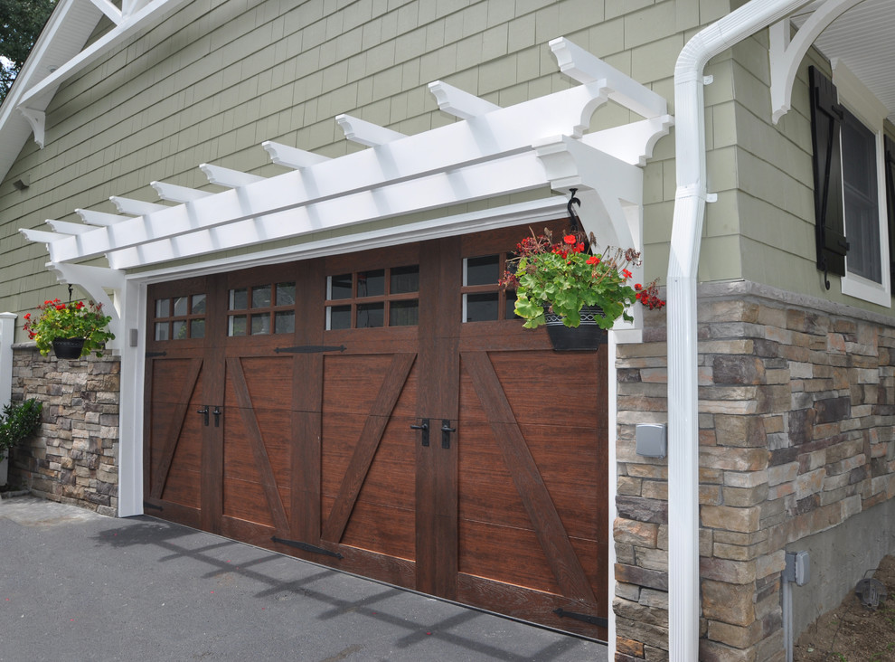 Photo of a mid-sized traditional attached two-car garage in New York.