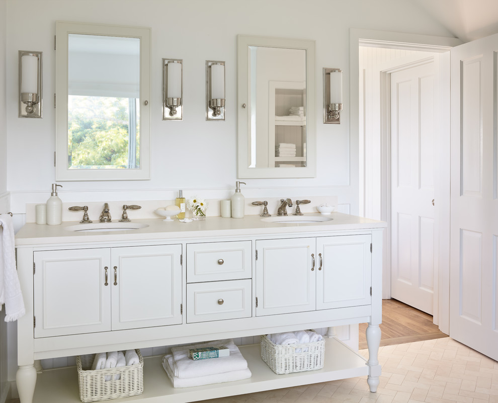 Design ideas for a beach style bathroom in Boston with white cabinets, white walls, an undermount sink, beige floor, white benchtops and recessed-panel cabinets.
