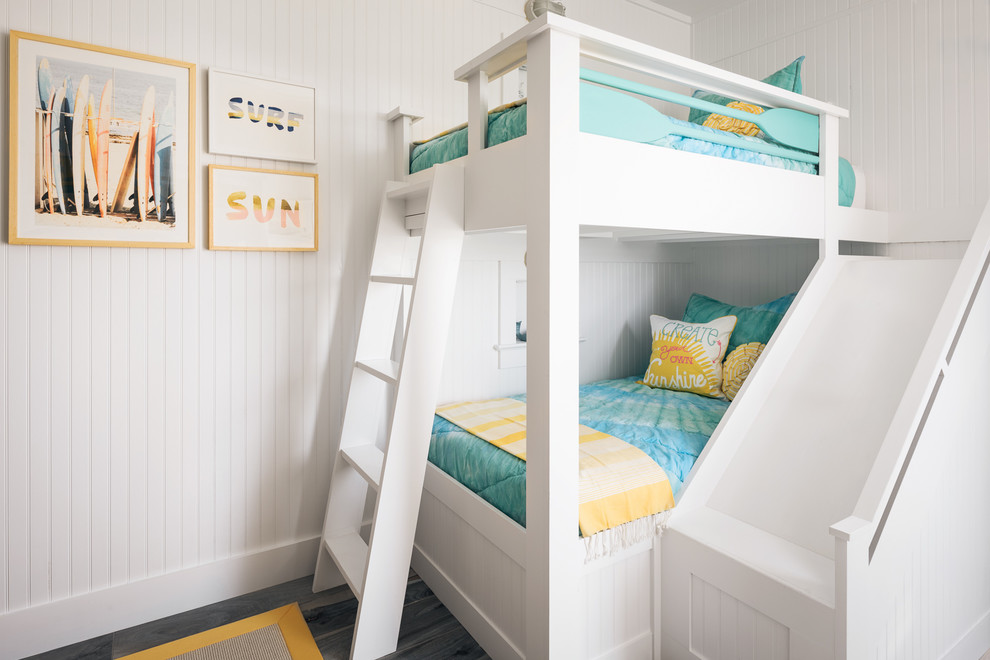 Mid-sized beach style gender-neutral kids' bedroom in Other with white walls, porcelain floors and blue floor.