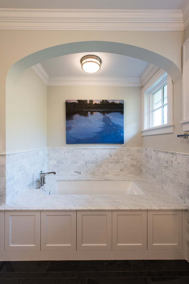 Inspiration for a large transitional master bathroom in Minneapolis with an undermount sink, recessed-panel cabinets, white cabinets, granite benchtops, an undermount tub, white tile, subway tile, an open shower, a two-piece toilet, grey walls and slate floors.