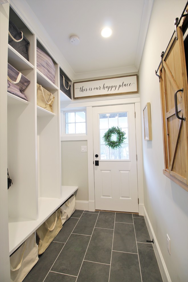 Mid-sized transitional porcelain tile and gray floor foyer photo in Boston with gray walls and a white front door