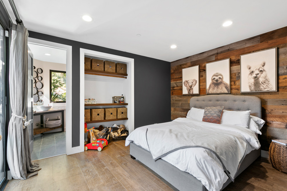 Photo of a transitional bedroom in Los Angeles with brown walls, dark hardwood floors, brown floor and wood walls.