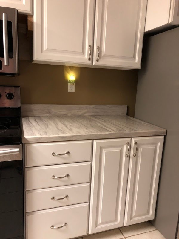 Eat-in kitchen - small galley eat-in kitchen idea with laminate countertops and no island