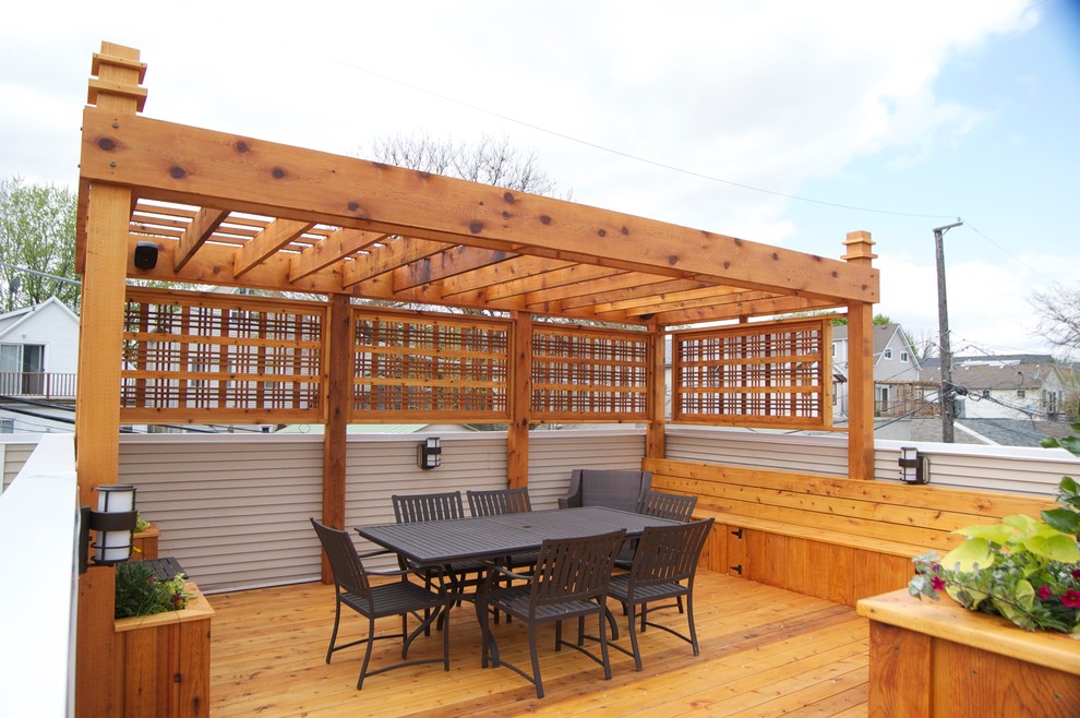 Design ideas for a mid-sized arts and crafts rooftop deck in Chicago with a pergola.