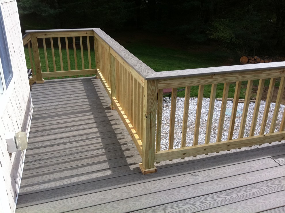 Example of a mid-sized backyard deck design in Boston with no cover
