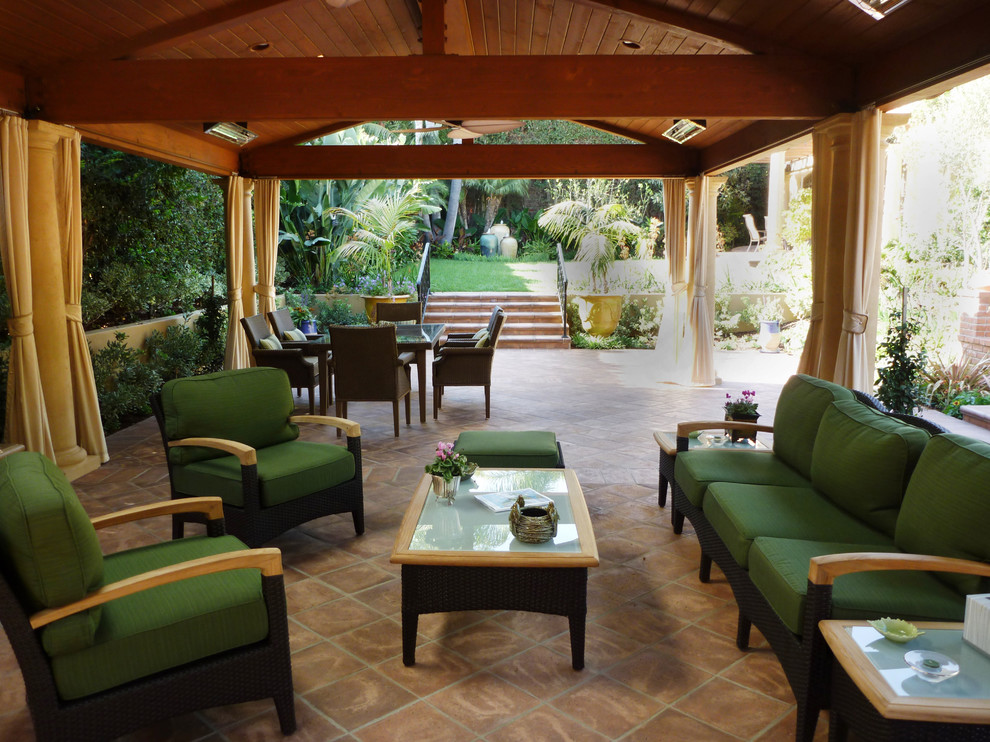 Design ideas for a traditional patio in Los Angeles with tile and a roof extension.