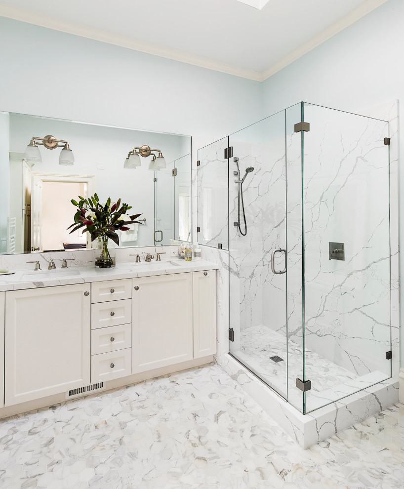 Corner shower - transitional white tile white floor and double-sink corner shower idea with recessed-panel cabinets, white cabinets, gray walls, an undermount sink, a hinged shower door, white countertops and a built-in vanity
