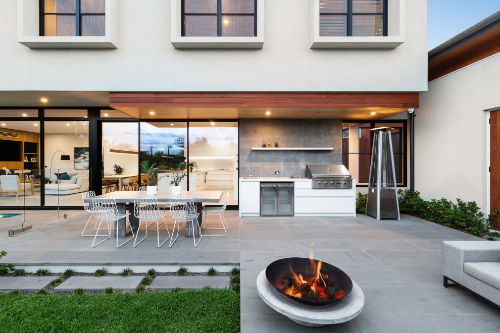 Design ideas for a contemporary patio in Melbourne with a fire feature and no cover.