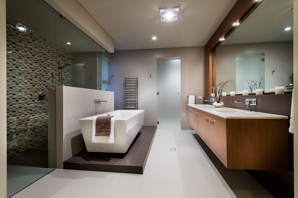 Photo of a contemporary master bathroom in Perth with flat-panel cabinets, medium wood cabinets, a freestanding tub, a curbless shower, multi-coloured tile, mosaic tile and grey walls.