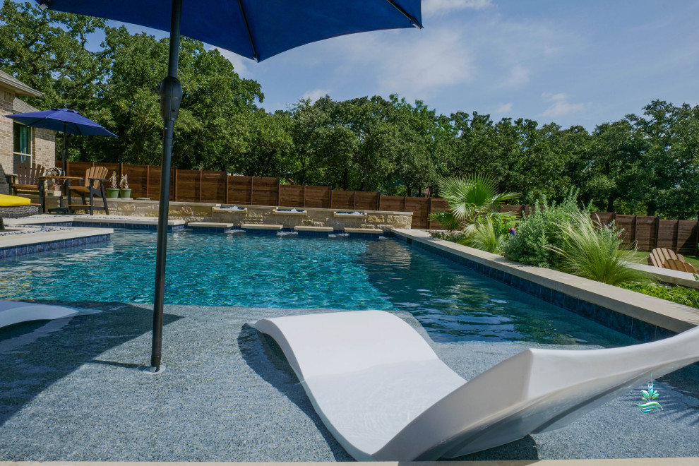 Pool landscaping - huge mediterranean backyard custom-shaped infinity pool landscaping idea in Dallas with decking