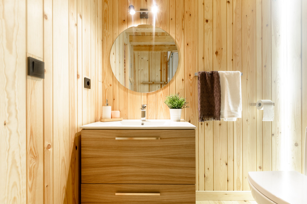 This is an example of a small scandinavian master bathroom in Other with furniture-like cabinets, white cabinets, a corner shower, light hardwood floors, a sliding shower screen, a single vanity, a floating vanity, wood and wood walls.