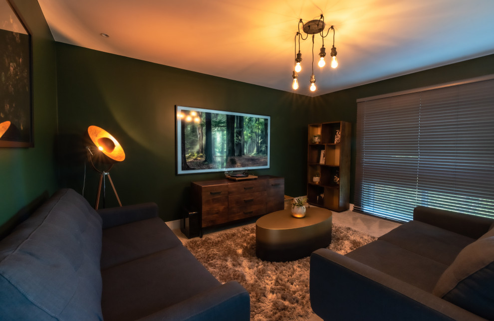 Medium sized industrial open plan living room in Kent with green walls, carpet, a wall mounted tv and feature lighting.