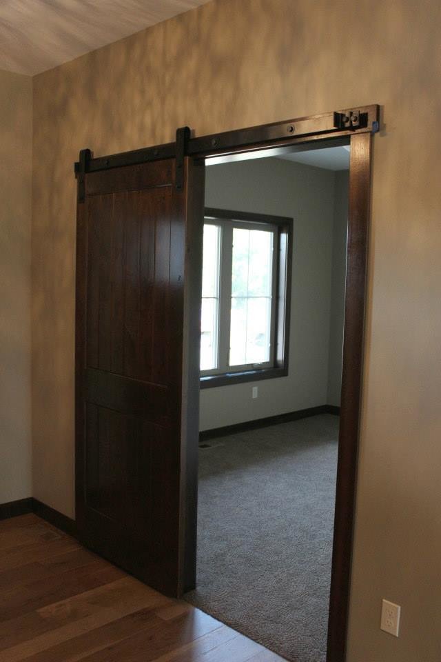 Example of a mid-sized transitional medium tone wood floor entry hall design with beige walls and a dark wood front door