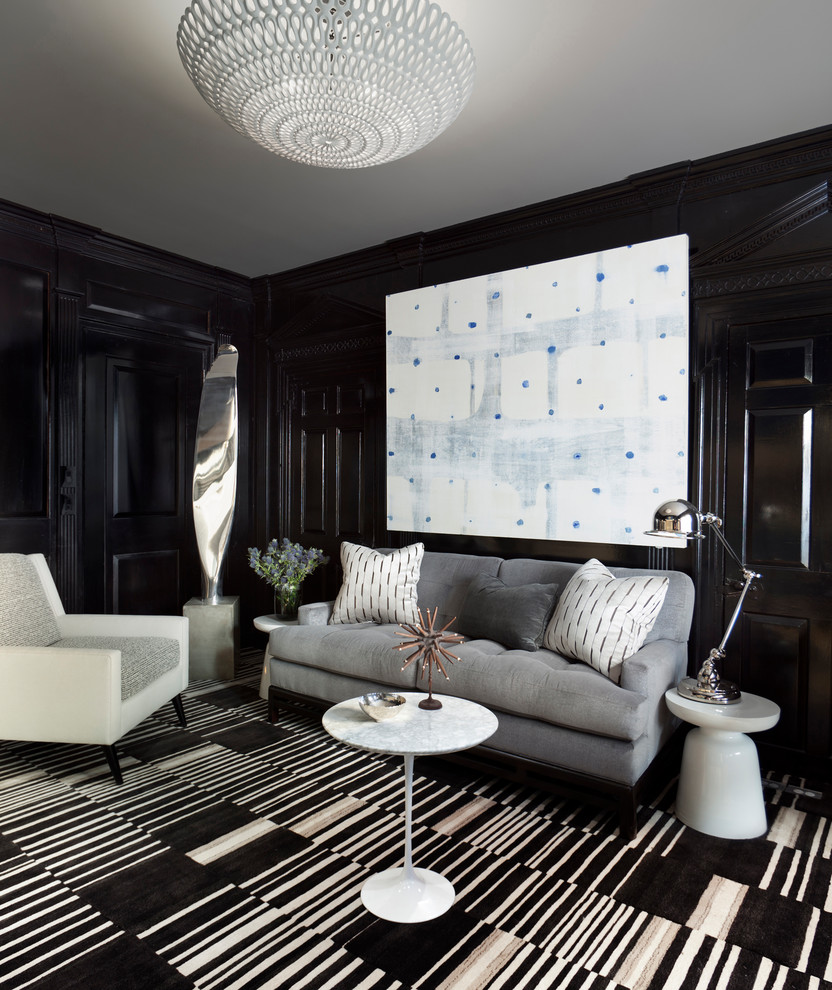 This is an example of a transitional living room in New York with black walls, carpet and multi-coloured floor.