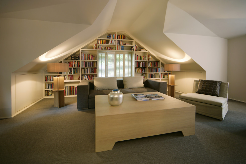 This is an example of a mid-sized contemporary enclosed living room in Hamburg with a library, white walls, carpet and no fireplace.