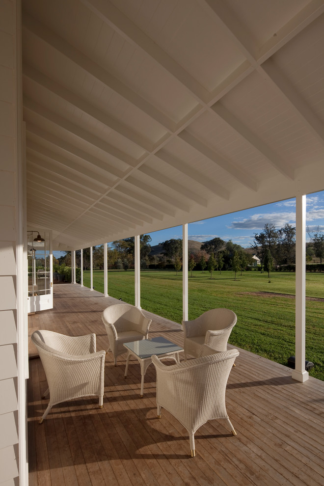 Inspiration for a large country front yard verandah in Sydney with decking and a roof extension.