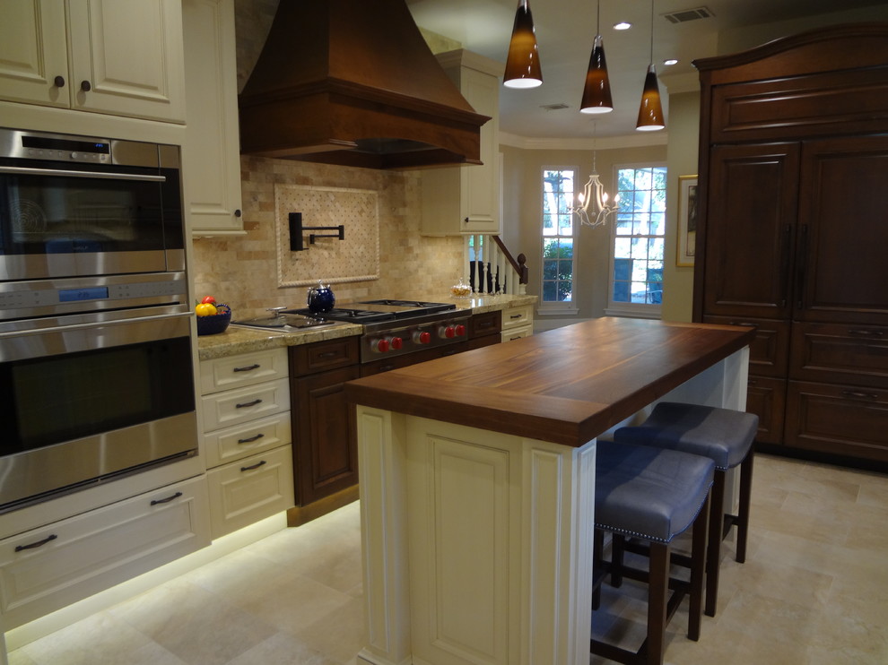 Large traditional u-shaped kitchen in Houston with white cabinets, beige splashback, ceramic floors and with island.